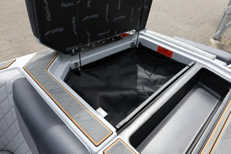 Slide: The Image of 2025 Tigé Z3 boat storage compartment with open lid, featuring quilted upholstery and sleek design. - 34