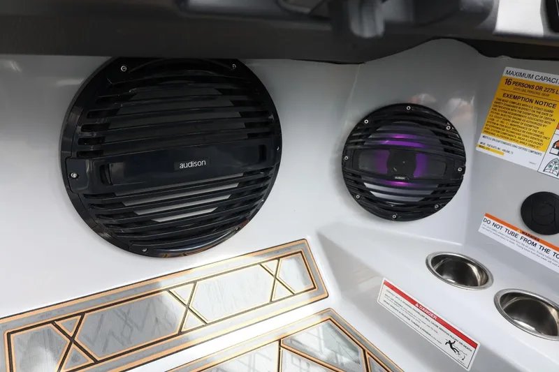 Slide: The Image of 2025 Tigé Z3 boat interior with Audison speakers and safety labels. - 37