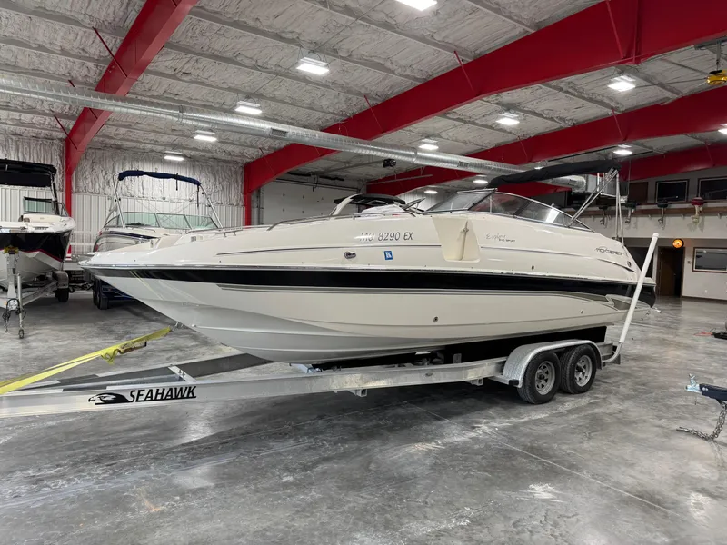 Slide: The Image of 2002 Monterey 240 Explorer Sport boat on trailer in indoor storage facility. - 1
