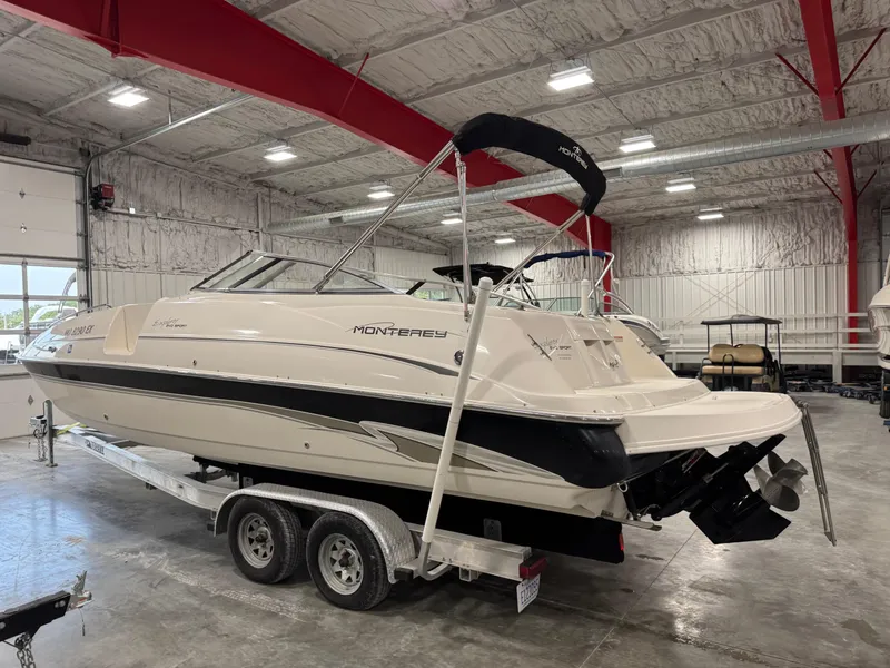 Slide: The Image of 2002 Monterey 240 Explorer Sport boat on trailer in indoor storage facility. - 3