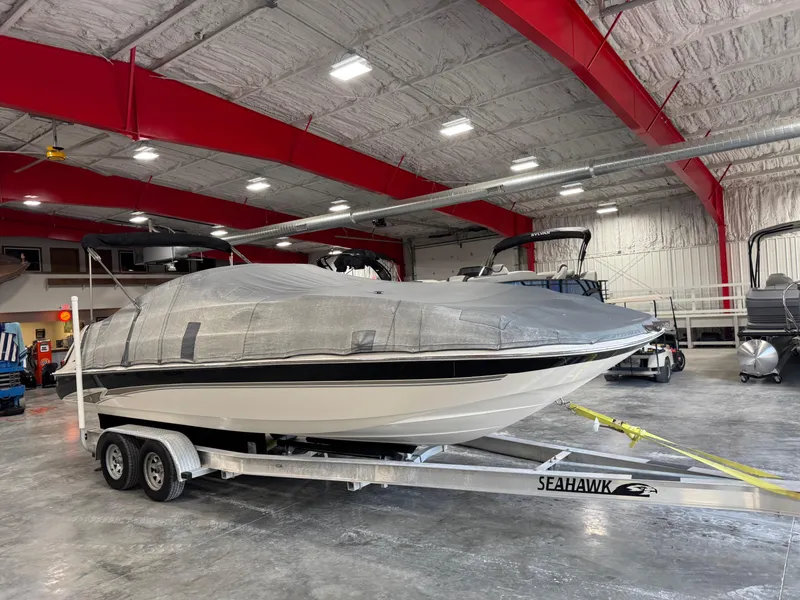 Slide: The Image of 2002 Monterey 240 Explorer Sport boat covered on trailer in indoor storage facility. - 5