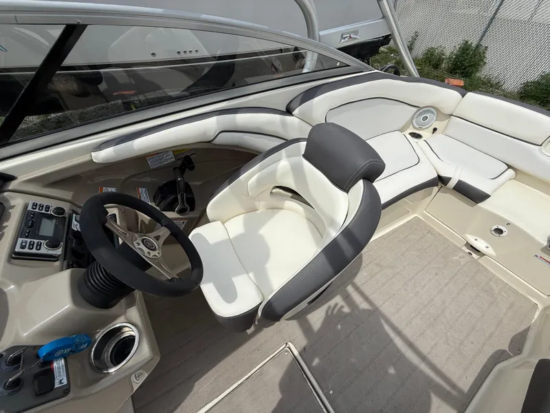 Slide: The Image of 2014 Yamaha Boats 242 Limited S interior with steering wheel and seating area. - 13