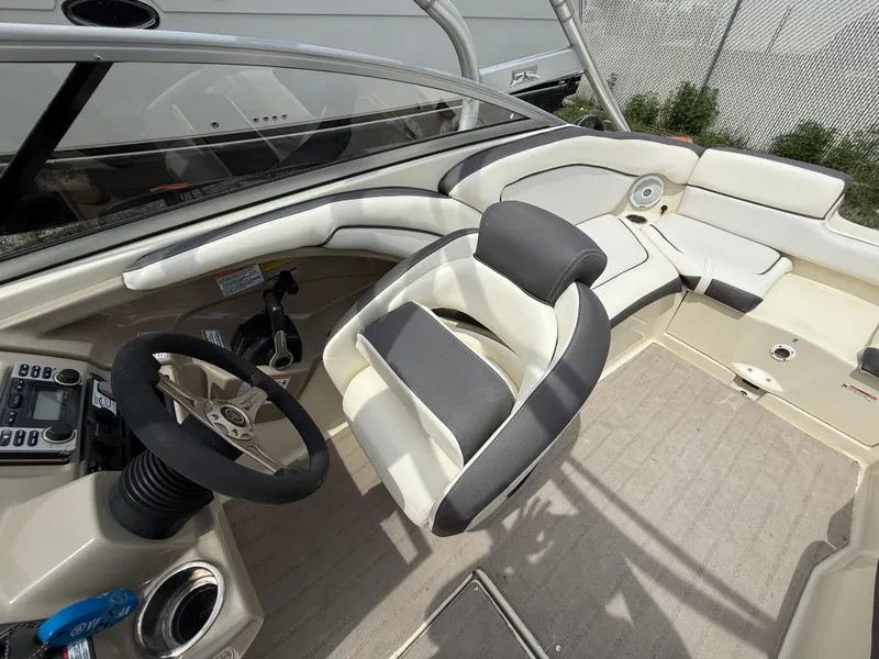 Slide: The Image of 2014 Yamaha Boats 242 Limited S interior with steering wheel and seating. - 14