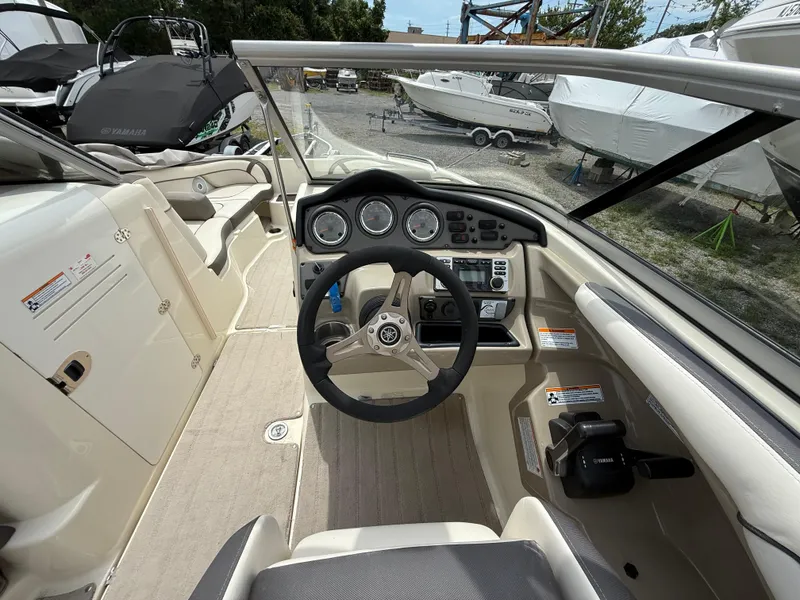 Slide: The Image of 2014 Yamaha Boats 242 Limited S cockpit with steering wheel and control panel. - 15