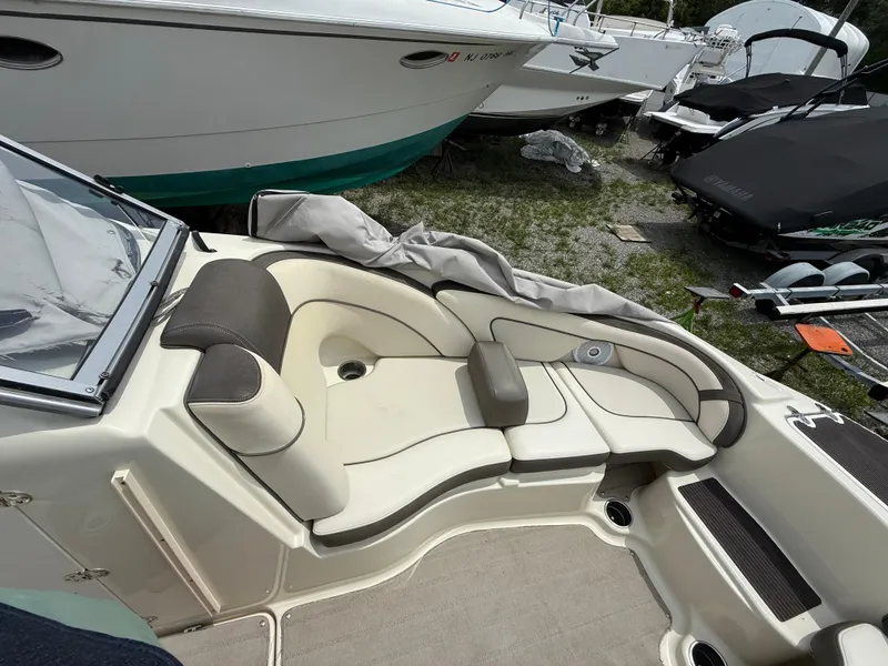 Slide: The Image of 2014 Yamaha Boats 242 Limited S interior with cushioned seating and storage compartments. - 16