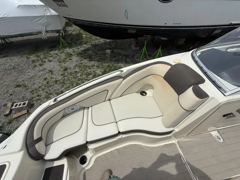 Slide: The Image of 2014 Yamaha Boats 242 Limited S interior seating area, featuring white and brown upholstery. - 17