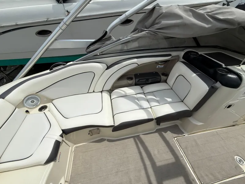 Slide: The Image of 2014 Yamaha Boats 242 Limited S interior with white seating and cup holders. - 19