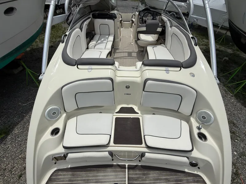 Slide: The Image of 2014 Yamaha Boats 242 Limited S interior with white seating and modern dashboard. - 8