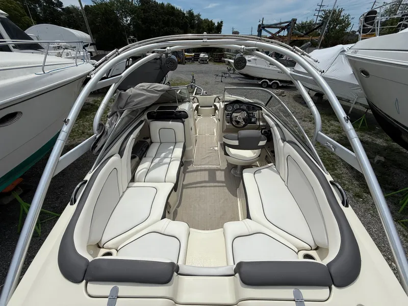 Slide: The Image of 2014 Yamaha Boats 242 Limited S interior with white seating and steering console. - 9