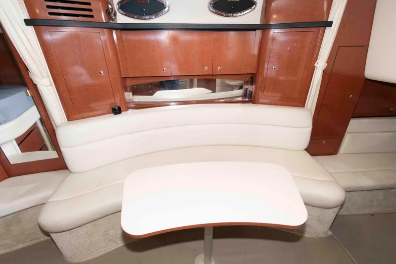Slide: The Image of 2004 Sea Ray 340 Sundancer helm with gauges, controls, and steering wheel, overlooking water. - 14