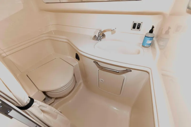 Slide: The Image of 2004 Sea Ray 340 Sundancer docked at marina, featuring spacious cockpit and seating area. - 17