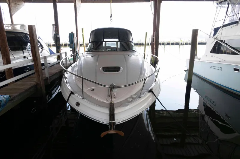 Slide: The Image of 2004 Sea Ray 340 Sundancer cruising on a calm lake under clear skies. - 2