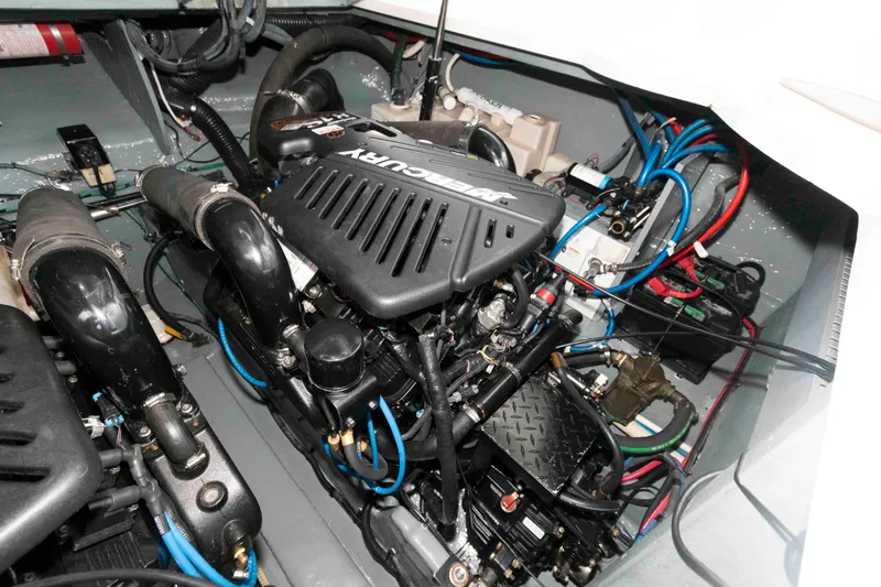 Slide: The Image of Engine compartment of a 2004 Sea Ray 340 Sundancer boat, featuring a Mercury engine. - 25
