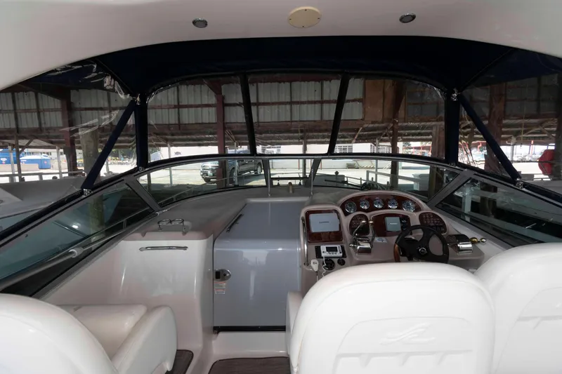 Slide: The Image of 2004 Sea Ray 340 Sundancer boat interior with seating and table at marina. - 5