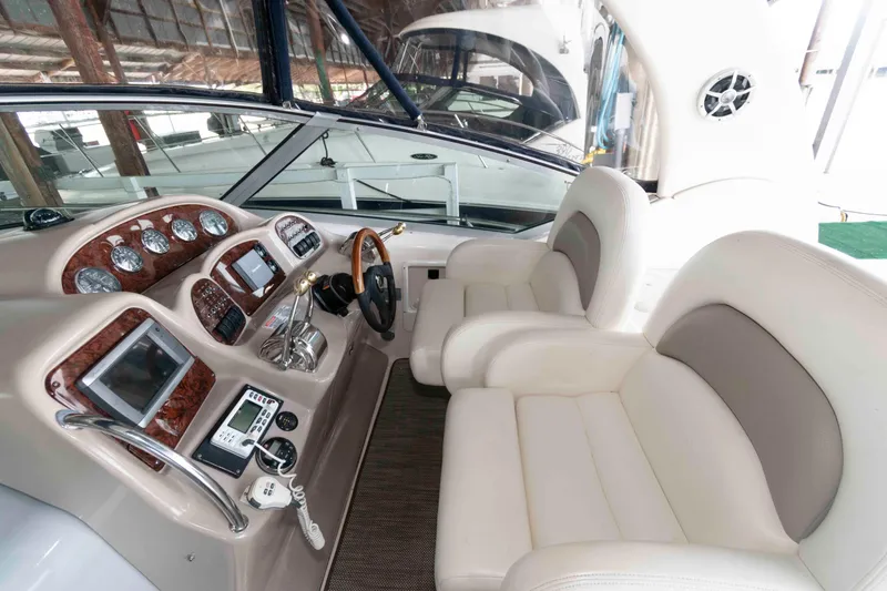 Slide: The Image of 2004 Sea Ray 340 Sundancer boat interior with seating and table, docked at marina. - 6