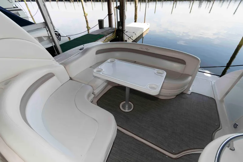 Slide: The Image of 2004 Sea Ray 340 Sundancer cockpit with steering wheel, gauges, and navigation equipment. - 9