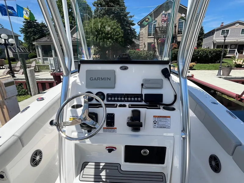 Slide: The Image of 2023 Sea Fox 248 Commander boat console with Garmin navigation system, docked near waterfront homes. - 10