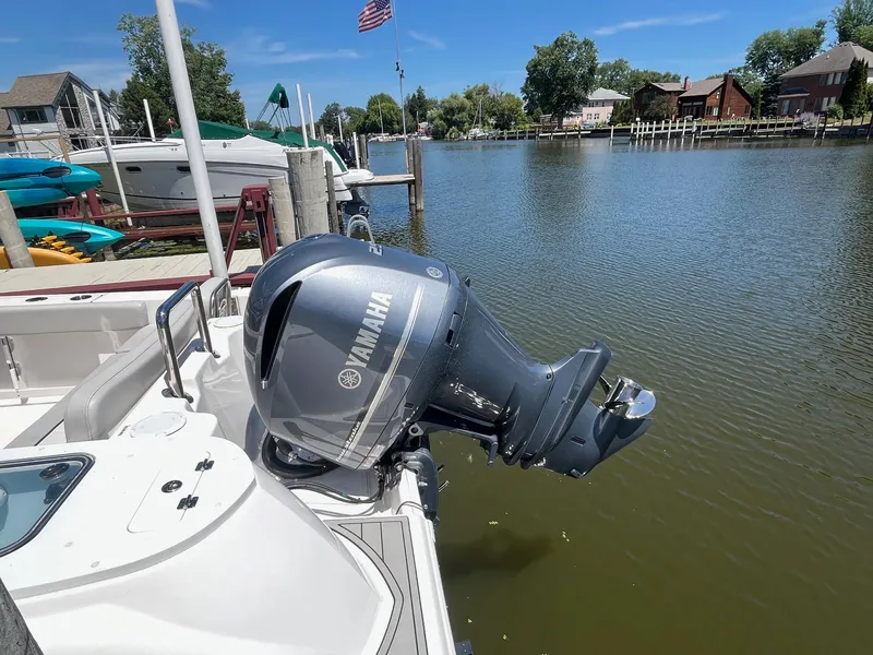 Slide: The Image of 2023 Sea Fox 248 Commander with Yamaha outboard motor docked by a scenic waterfront. - 4
