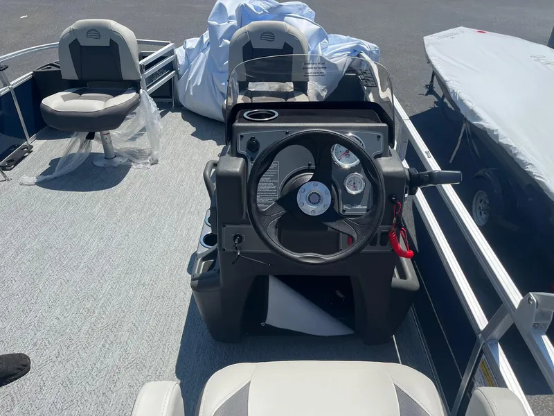 Slide: The Image of 2026 Sun Tracker Bass Buggy 18 DLX boat interior with steering console and seating. - 10