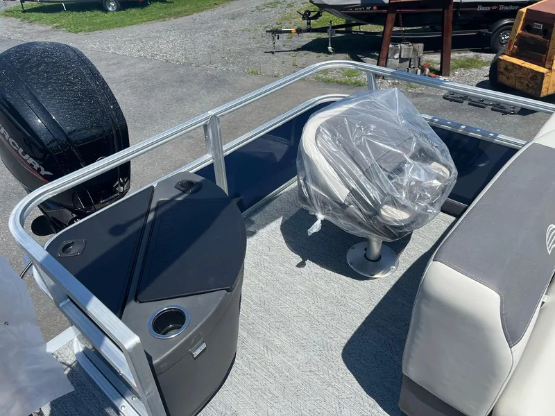 Slide: The Image of 2026 Sun Tracker Bass Buggy 18 DLX pontoon boat interior with seating and motor. - 13