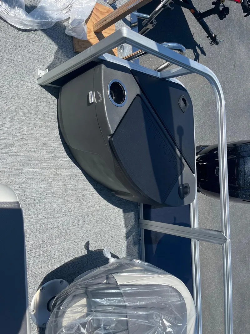 Slide: The Image of 2026 Sun Tracker Bass Buggy 18 DLX boat interior with seating and storage compartment. - 15