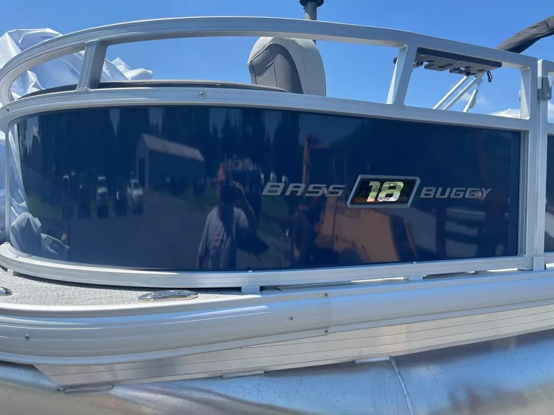 Slide: The Image of 2026 Sun Tracker Bass Buggy 18 DLX pontoon boat with reflective blue paneling. - 3
