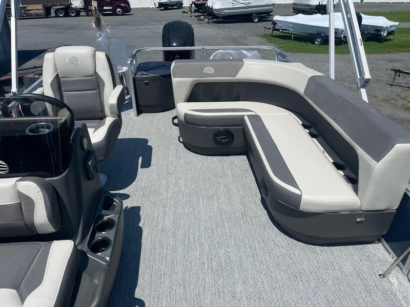 Slide: The Image of 2026 Sun Tracker Bass Buggy 18 DLX pontoon boat interior with plush seating and modern design. - 6