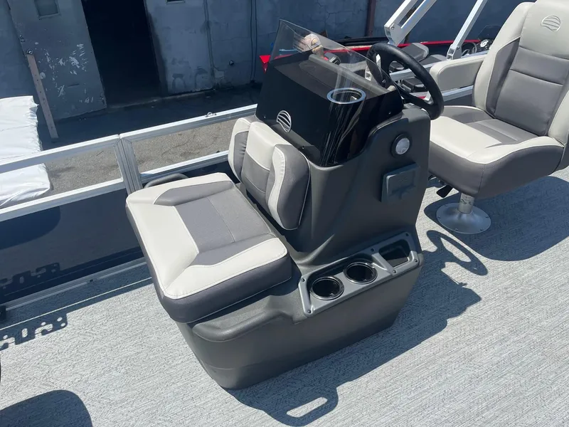 Slide: The Image of 2026 Sun Tracker Bass Buggy 18 DLX boat interior with steering console and seating. - 8