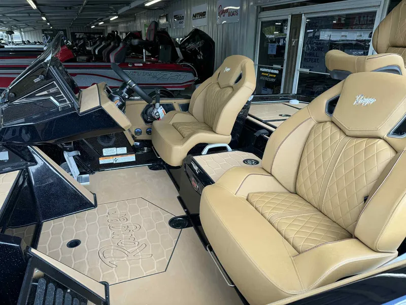 Slide: The Image of 2025 Ranger Z520R Cup-Equipped boat interior with tan quilted seats and sleek dashboard. - 12