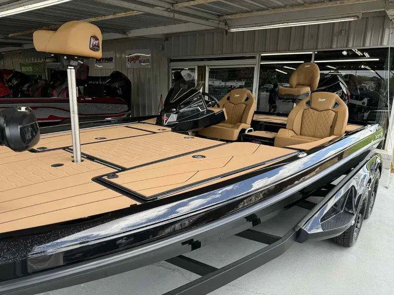 Slide: The Image of 2025 Ranger Z520R Cup-Equipped boat with tan seating and sleek design in showroom. - 5