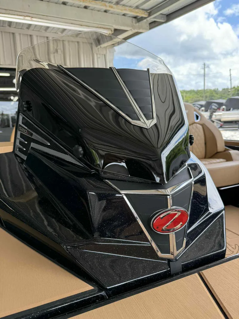 Slide: The Image of 2025 Ranger Z520R Cup-Equipped boat, sleek black design, under a covered area. - 8