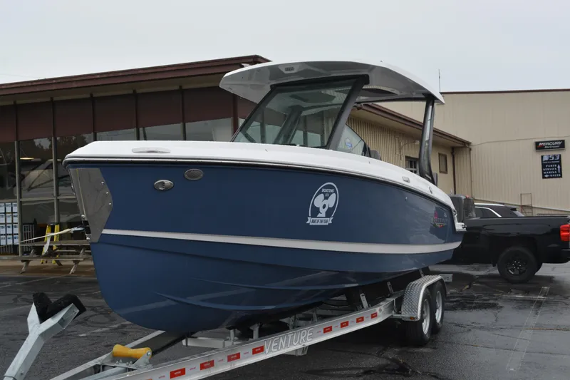 The Image of 2026 Monterey Elite 25 SD boat on trailer, parked outside a building. - 0