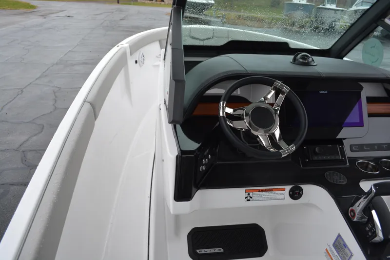 Slide: The Image of 2026 Monterey Elite 25 SD boat dashboard with steering wheel and control panel. - 12