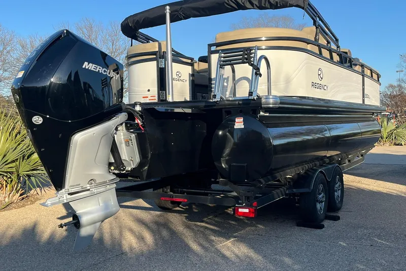 Slide: The Image of 2025 Regency 230 DL3 pontoon boat with Mercury outboard engine on trailer. - 3