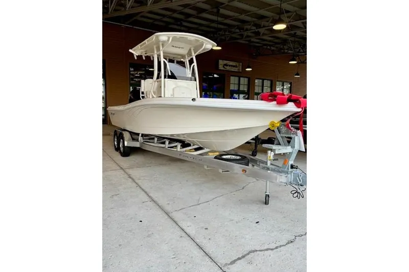 The Image of 2025 Ranger 2510 Bay boat on trailer in showroom setting. - 0