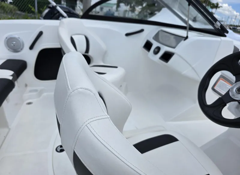 Slide: The Image of 2024 Tahoe 185 S boat interior with white seating and steering wheel. - 4