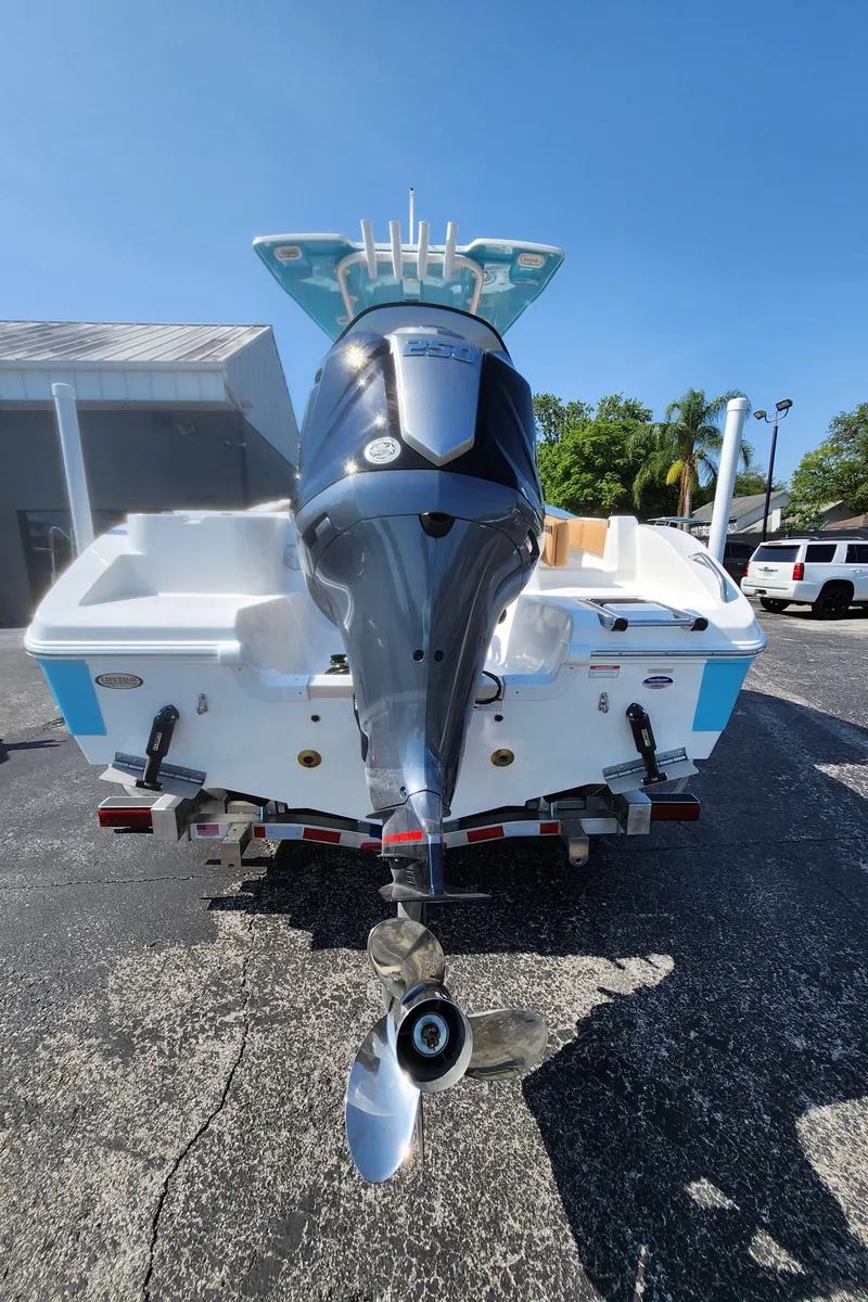 Slide: The Image of 2025 NauticStar 222 OSL boat with powerful outboard motor, parked on a trailer. - 3