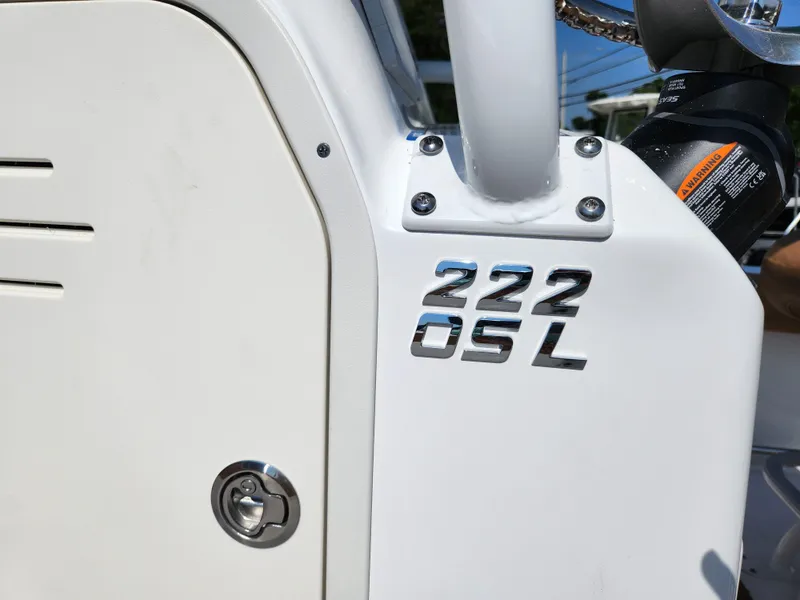 Slide: The Image of 2025 NauticStar 222 OSL boat detail with model emblem and hardware. - 8