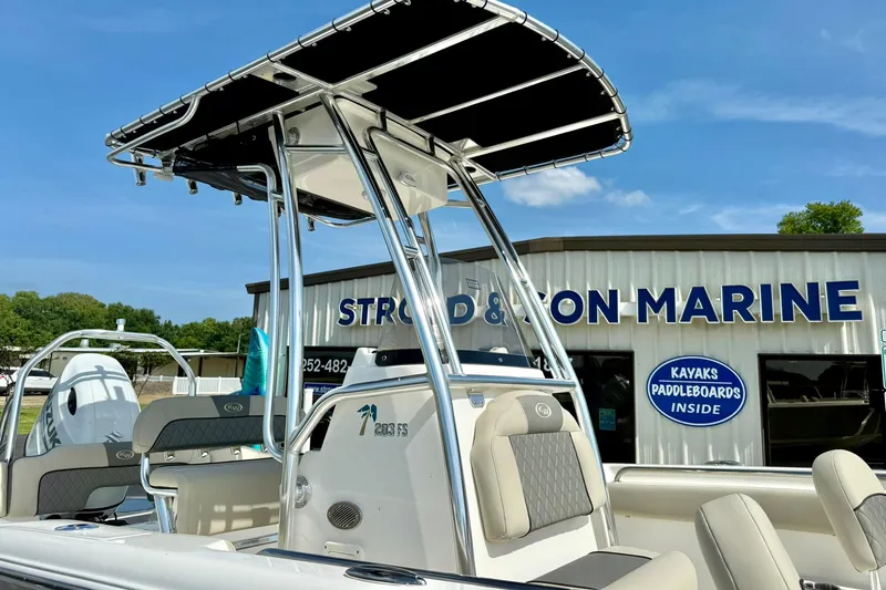 Slide: The Image of 2025 Key West 203 FS boat with T-top, displayed at marine dealership. - 10