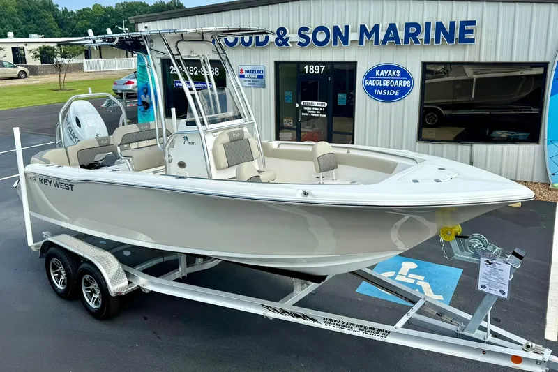 Slide: The Image of 2025 Key West 203 FS boat on trailer outside marine dealership. - 11