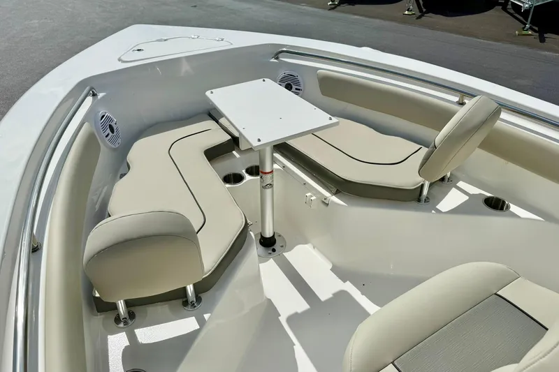 Slide: The Image of 2025 Key West 203 FS boat interior with beige seating and a central table. - 14