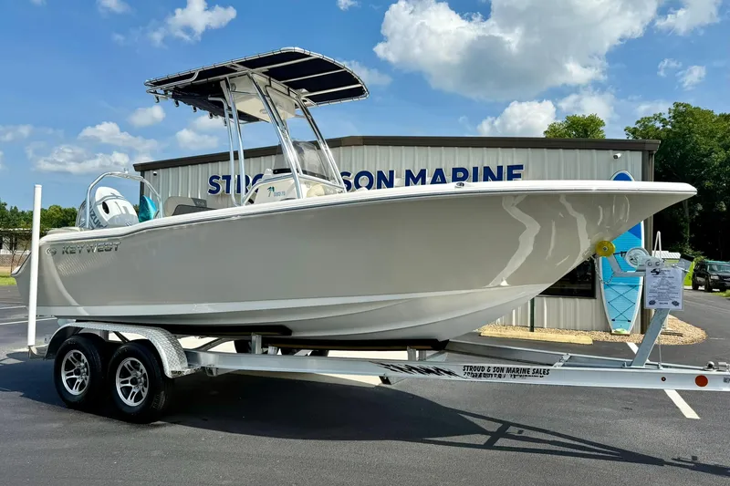 Slide: The Image of 2025 Key West 203 FS boat on trailer at dealership, sunny day. - 4
