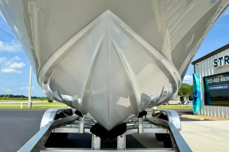 Slide: The Image of 2025 Key West 203 FS boat on trailer, close-up of hull design. - 8