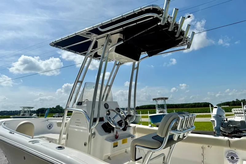 Slide: The Image of 2025 Key West 203 FS boat with T-top and console, set against a clear blue sky. - 9