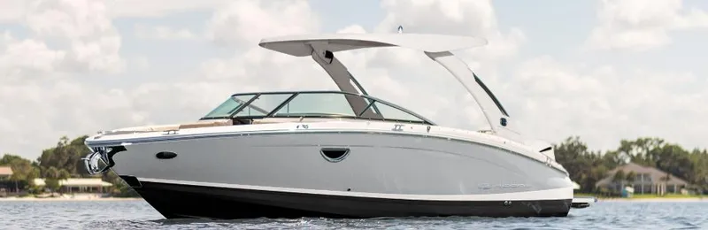 The Image of 2026 Regal LX6 boat on water under a cloudy sky. - 0