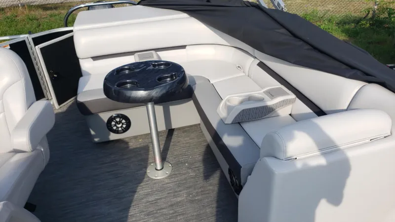 Slide: The Image of Luxurious Sweetwater SW2086c pontoon boat interior with plush seating and table, 2023 model. - 8
