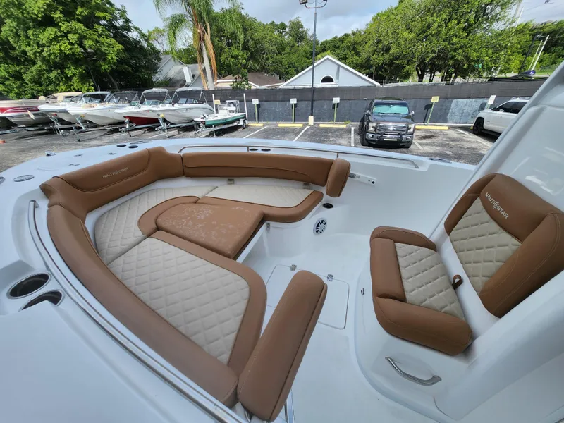 Slide: The Image of 2026 NauticStar 252 Legacy boat with luxurious tan seating and spacious deck. - 11