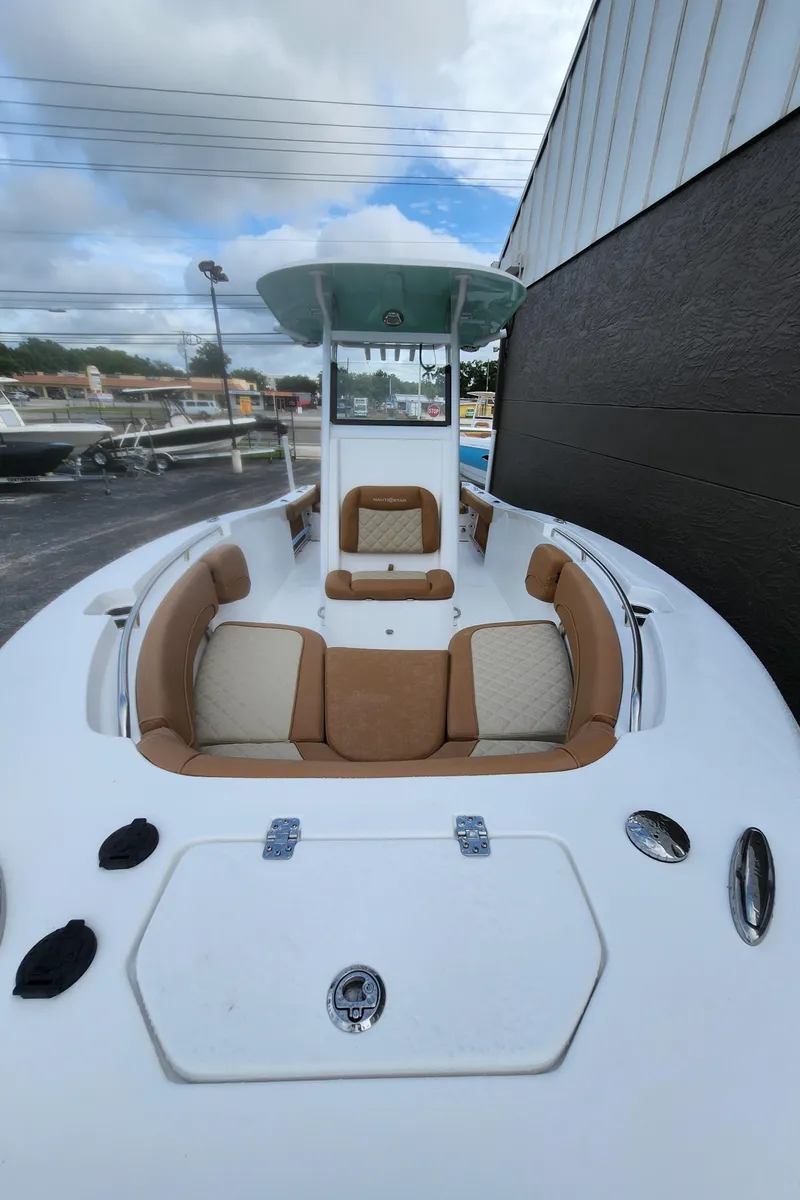 Slide: The Image of 2026 NauticStar 252 Legacy boat with tan seating and sleek design. - 13