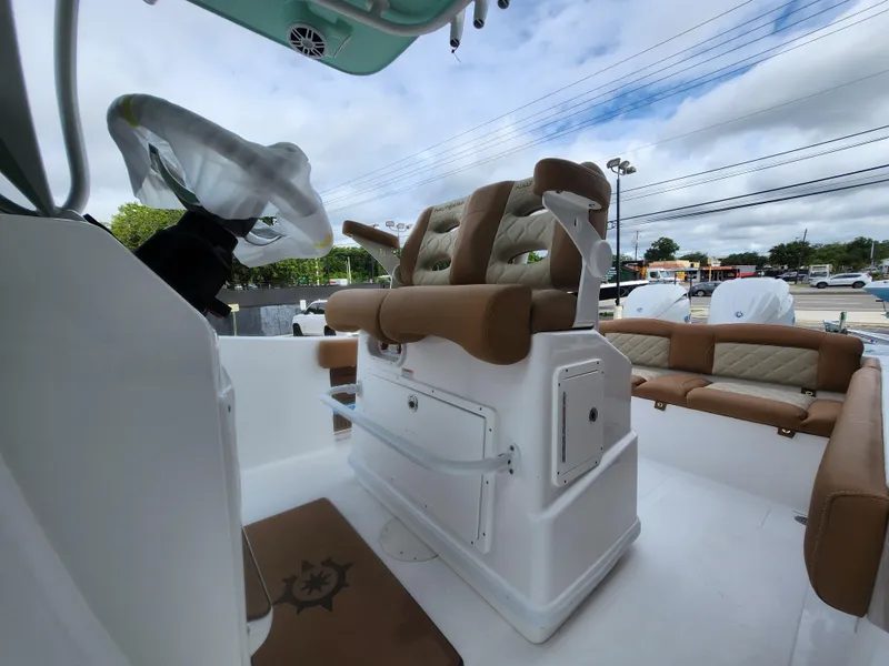 Slide: The Image of 2026 NauticStar 252 Legacy boat interior with cushioned seating and steering wheel. - 7
