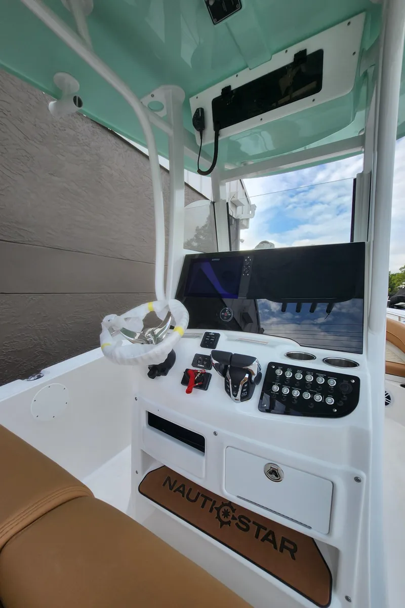 Slide: The Image of 2026 NauticStar 252 Legacy boat dashboard with modern controls and steering wheel. - 8